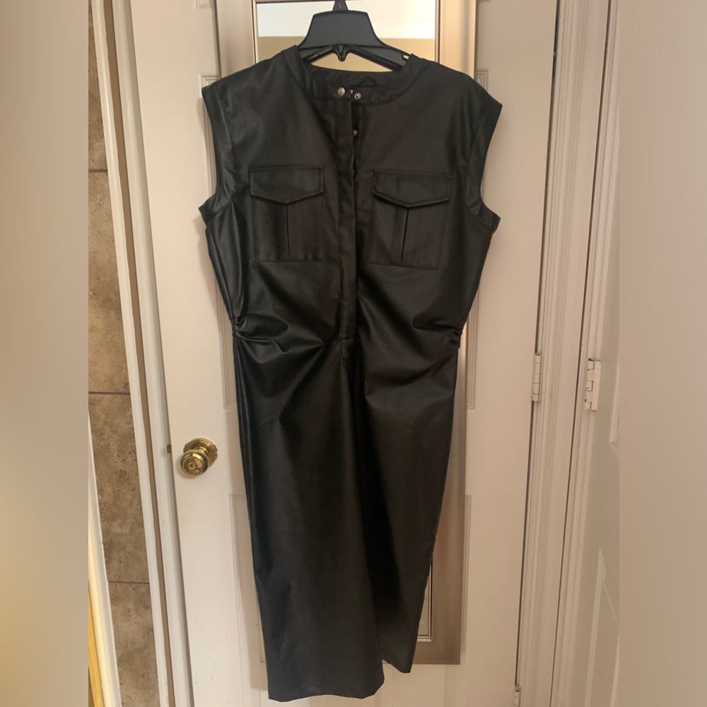 Just Bellini black sleeveless snaps half way down the front.  New with tags